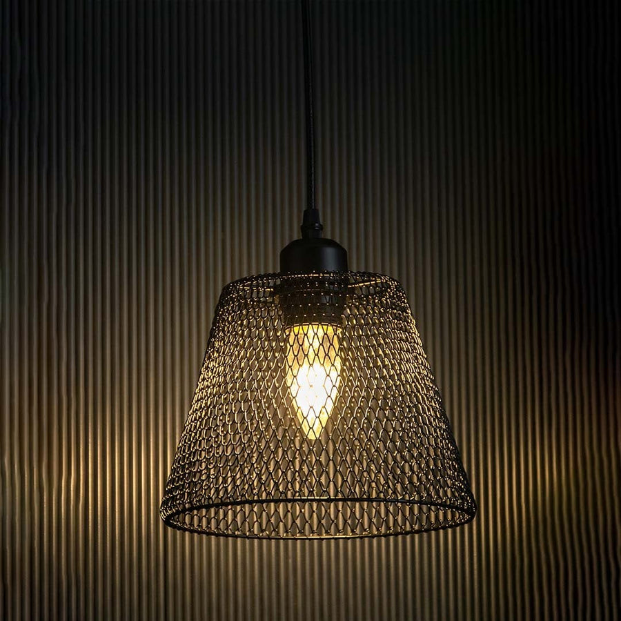 Black mesh pendant light glowing warmly against a dark background highlighting the 20 cm height and 20 cm width of the intricate mesh shade.