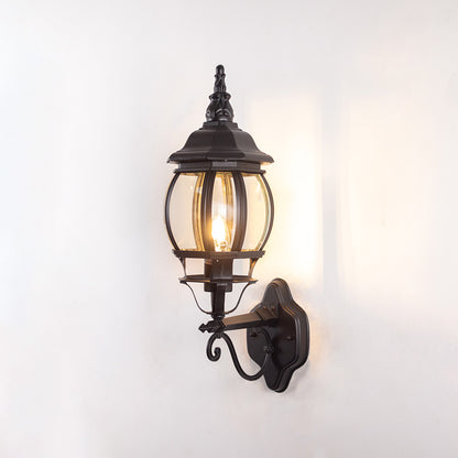 Black metal outdoor lantern wall light on white background with decorative mount for stylish patio decor.