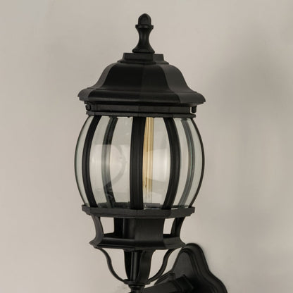 Closeup view of black metal finish and vertical ribbed glass texture of the traditional outdoor wall lighting fixture detail.