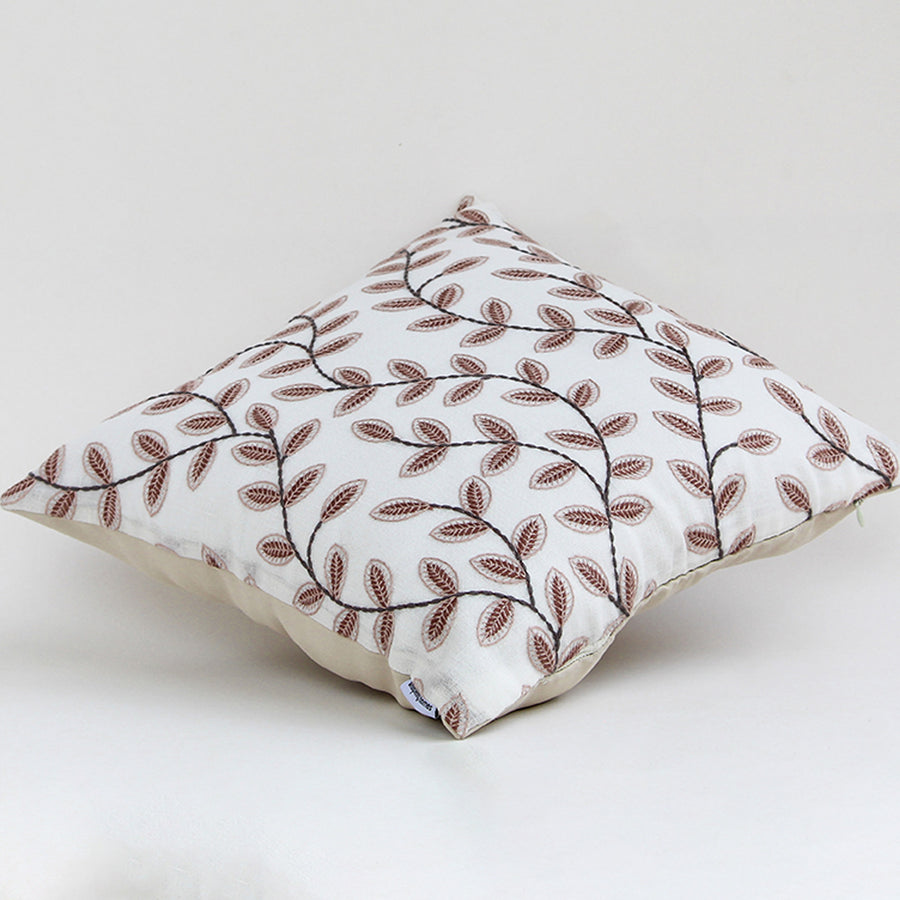 Cotton cushion with brown embroidered leaf pattern displayed on a white background highlighting detailed stitching and soft fabric texture for home styling.