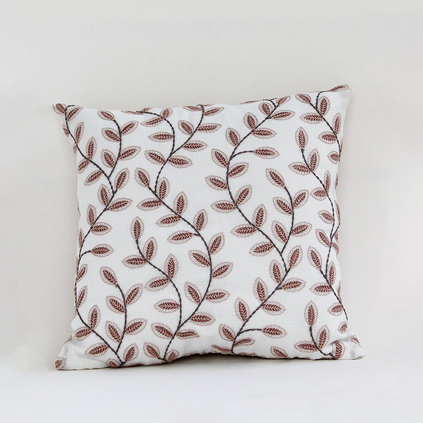 White cotton cushion cover with brown botanical leaf print for sofa bedroom seating and stylish interior decor accents.