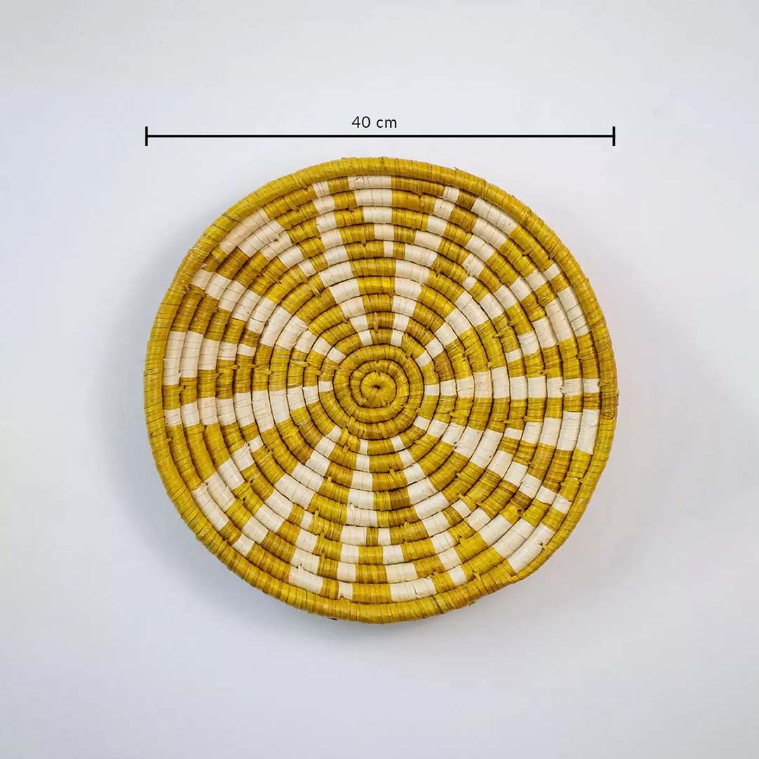 Handwoven round wall basket in yellow and natural fiber showing 30 cm diameter designed for decorative interior wall placement.