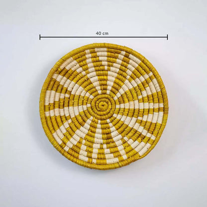 Handwoven round wall basket in yellow and natural fiber showing 30 cm diameter designed for decorative interior wall placement.