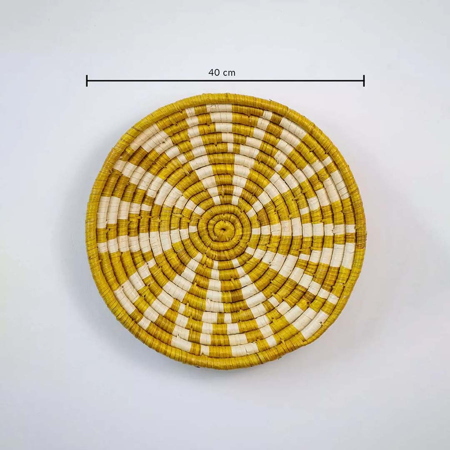 Handwoven round wall basket in yellow and natural fiber showing 30 cm diameter designed for decorative interior wall placement.