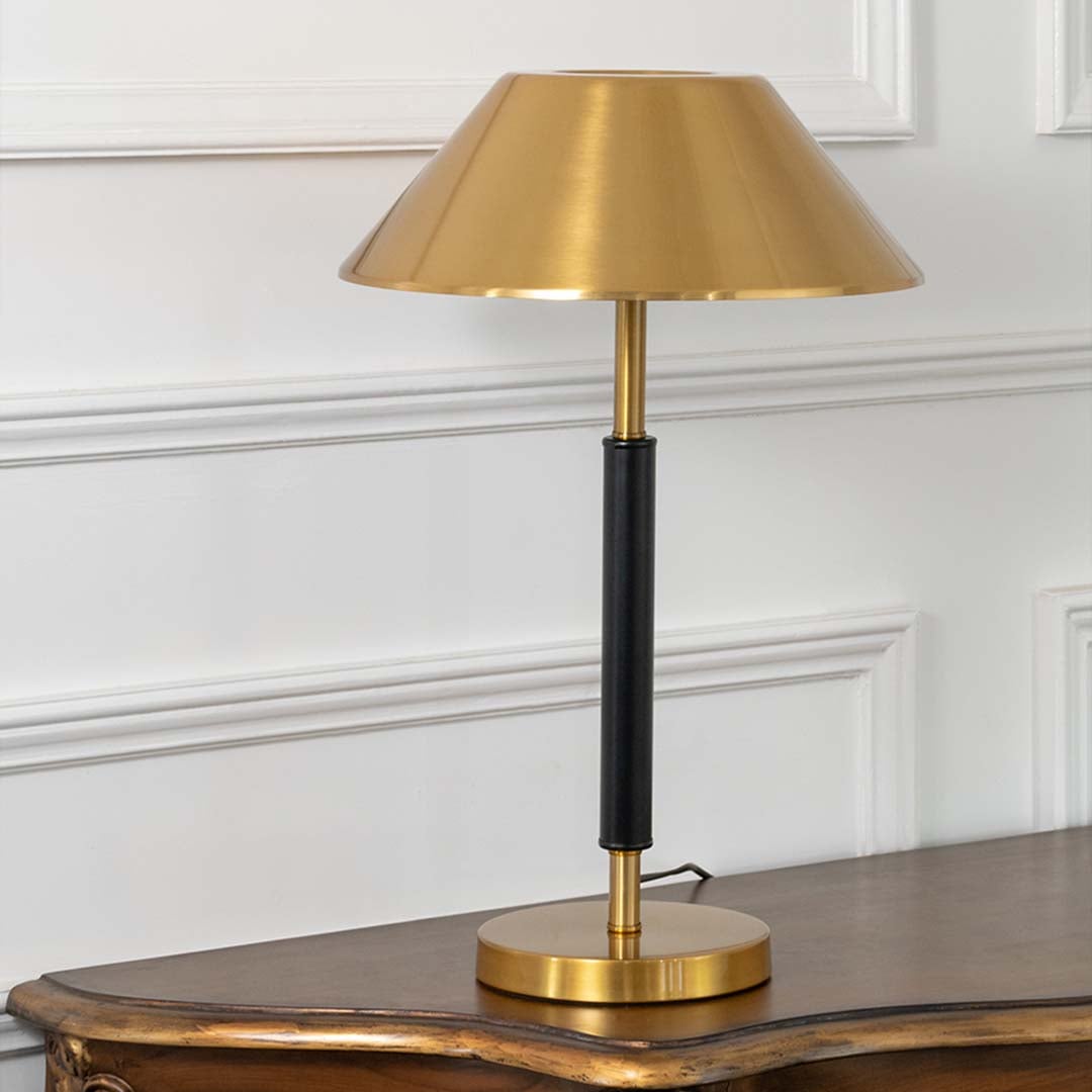 Gold metal table lamp with black stem and metallic shade for luxury modern tabletop lighting decor styling.