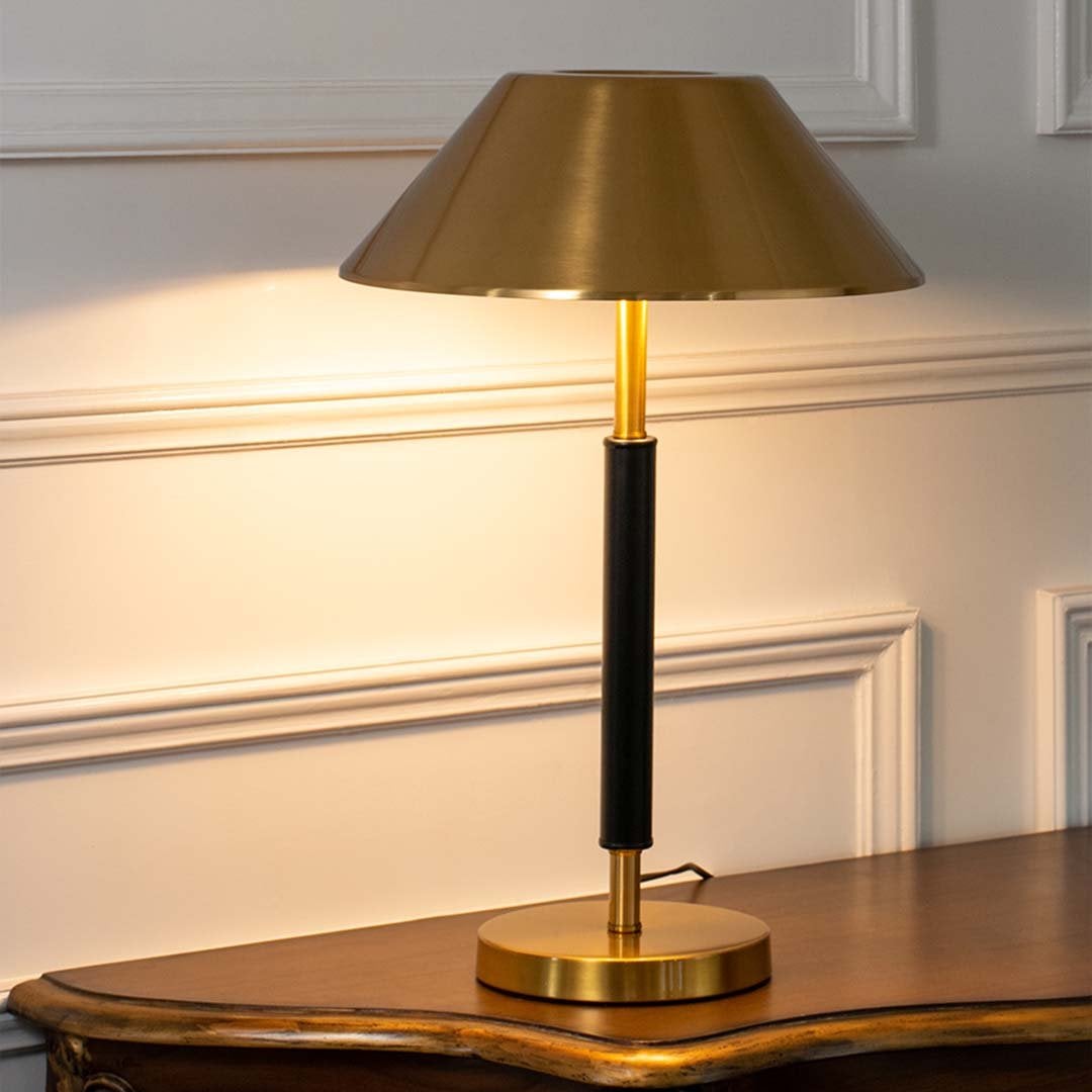 Gold metal table lamp with warm ambient glow for elegant modern bedside lighting decor styling ideas.