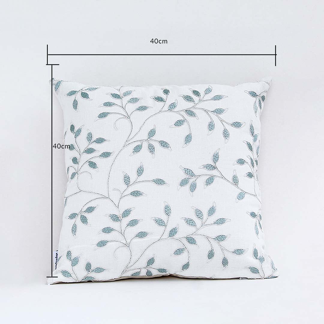 White cushion cover with soft teal leaf pattern displayed with clear lines showing its 40 cm x 40 cm measurement guiding buyers to select accurate home décor sizing.