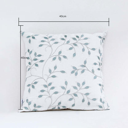 White cushion cover with soft teal leaf pattern displayed with clear lines showing its 40 cm x 40 cm measurement guiding buyers to select accurate home décor sizing.