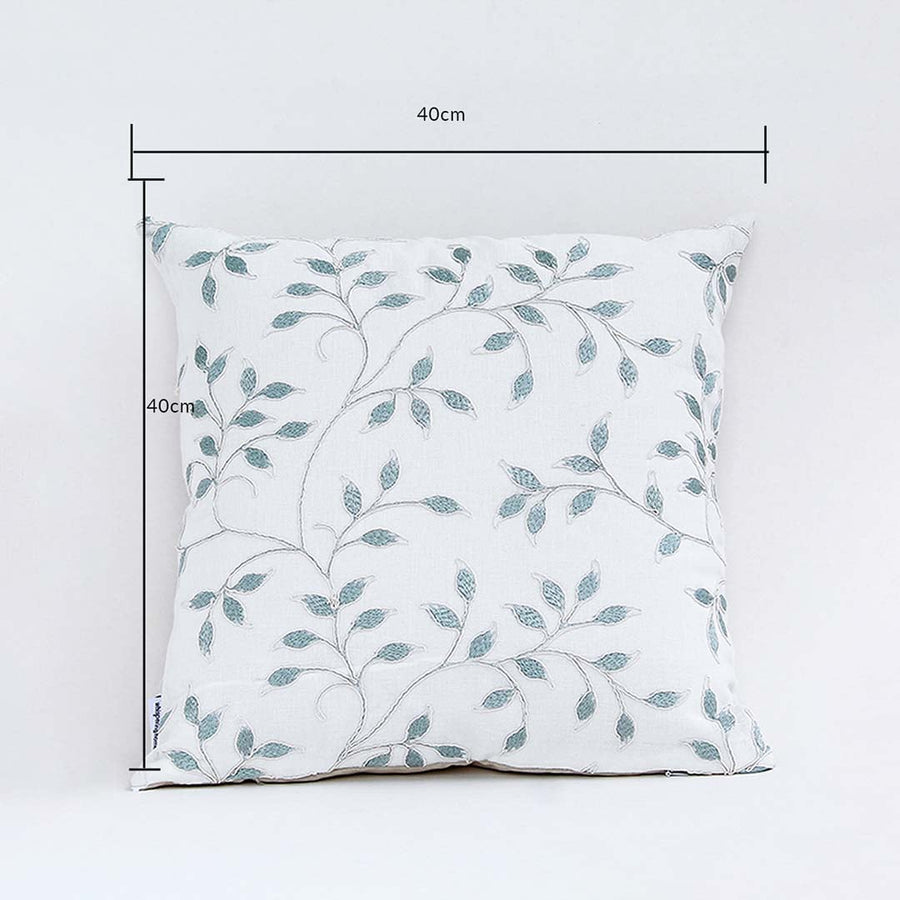 White cushion cover with soft teal leaf pattern displayed with clear lines showing its 40 cm x 40 cm measurement guiding buyers to select accurate home décor sizing.