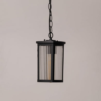Black metal lantern with ribbed glass shown on white background displaying sleek outdoor lighting design.