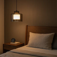 Smoky glass pendant light beside the bed creating warm ambiance with sophisticated modern elegance.