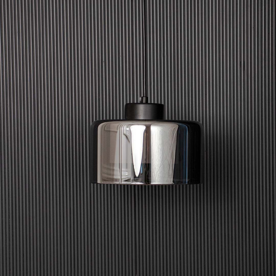 Smoked glass pendant light with black top modern ceiling lamp for luxury dining table and bedroom interiors black background view.