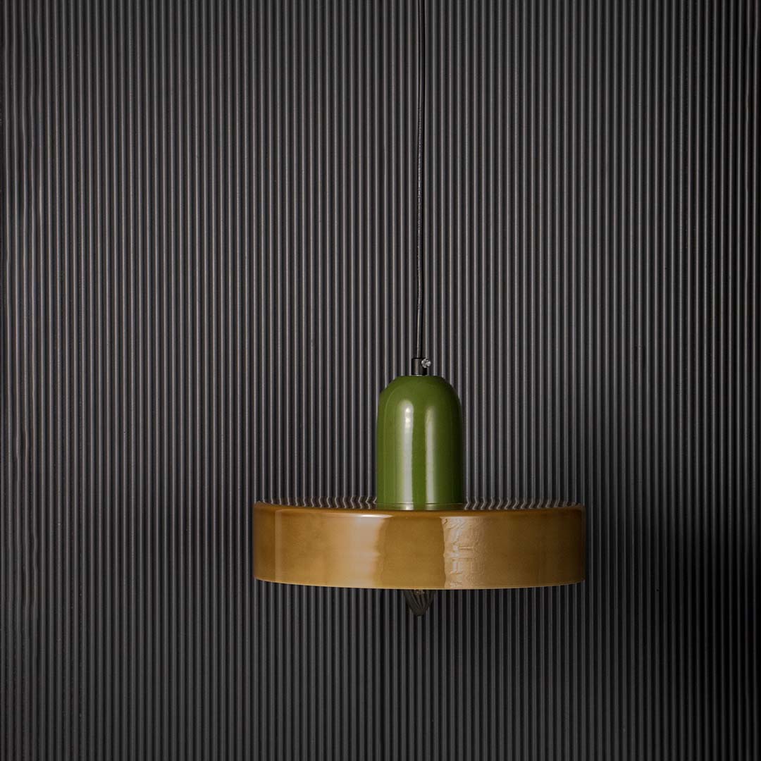 Green and brown two tone pendant ceiling light with round shape displayed stylishly against black background for modern decor.