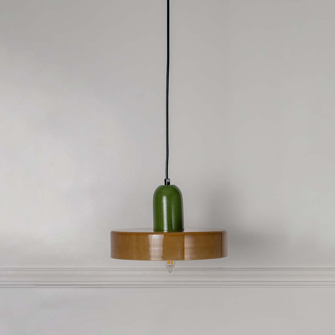 White feather pendant light with green and gold accents crafted for elegant modern living spaces.