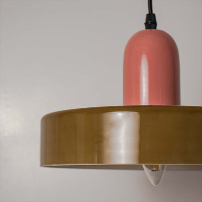 Closeup of pink and olive green pendant ceiling light showing glossy round finish and modern contemporary design style.