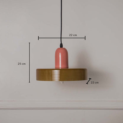 Pink and olive green pendant ceiling light with height 25 cm and width 22 cm shown clearly against plain off white background.