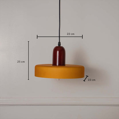 Mustard yellow and red pendant ceiling light with height 25 cm and width 22 cm shown clearly against plain off white background.