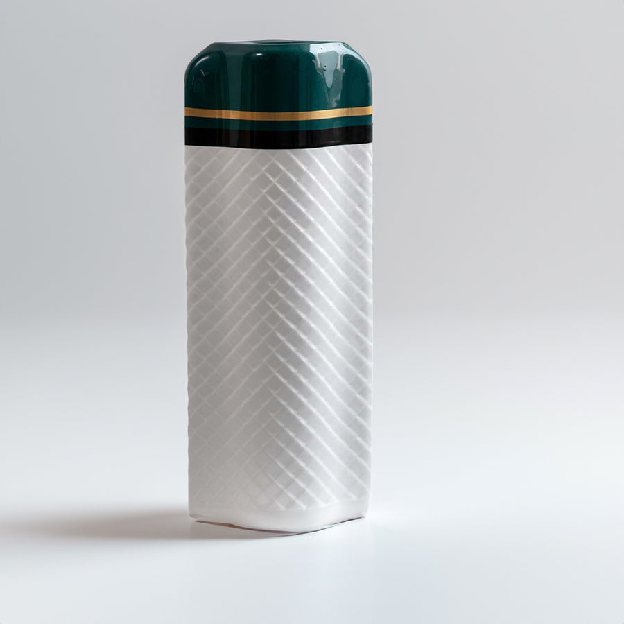 White ceramic cylinder vase with chevron textures and a glossy emerald green top collar on white background for elegant decor.