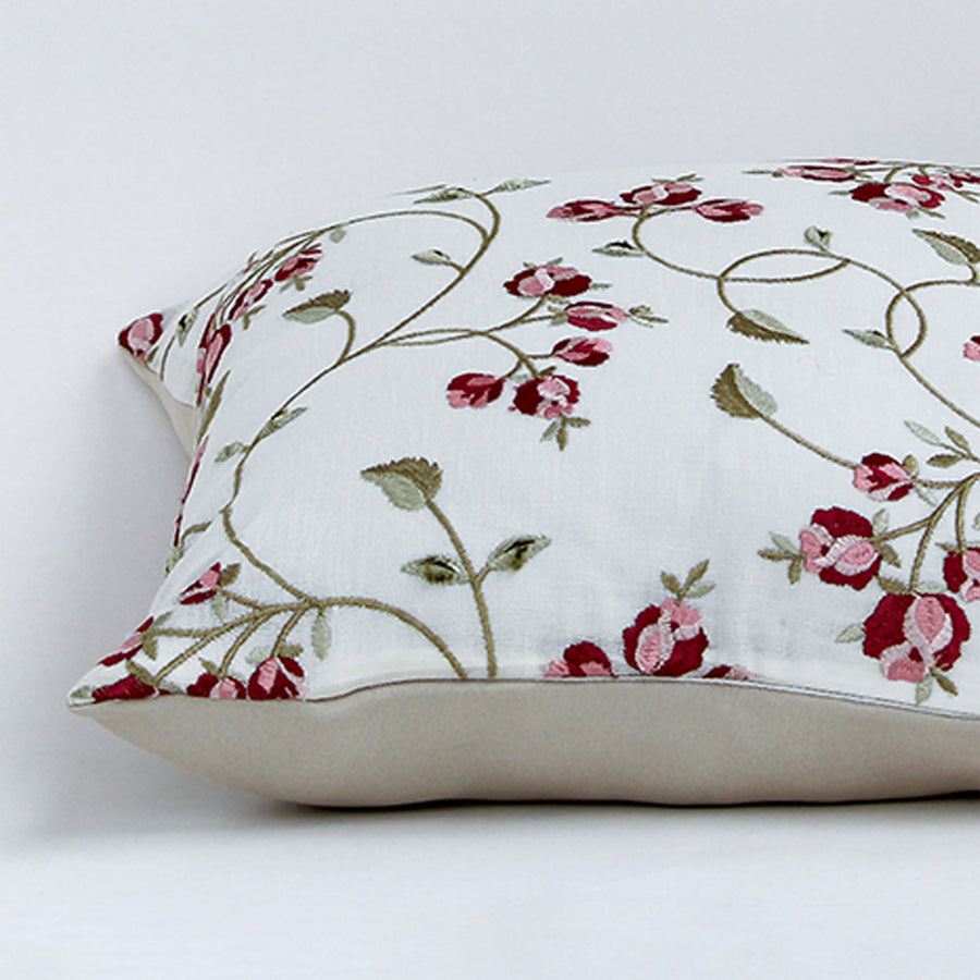 White cotton cushion cover with delicate red floral vine print showcasing smooth cotton fabric and quality craftsmanship.