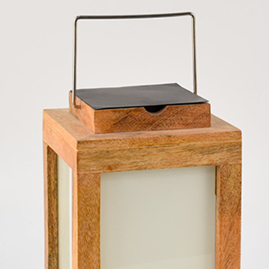 Closeup view of wooden solar lantern showing smooth natural wood texture frosted glass and detailed metal solar top finish.
