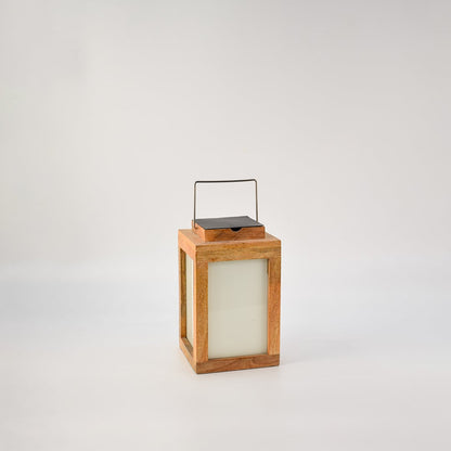 Wooden solar lantern showing natural mango wood frame frosted glass sides and modern rectangular shape.