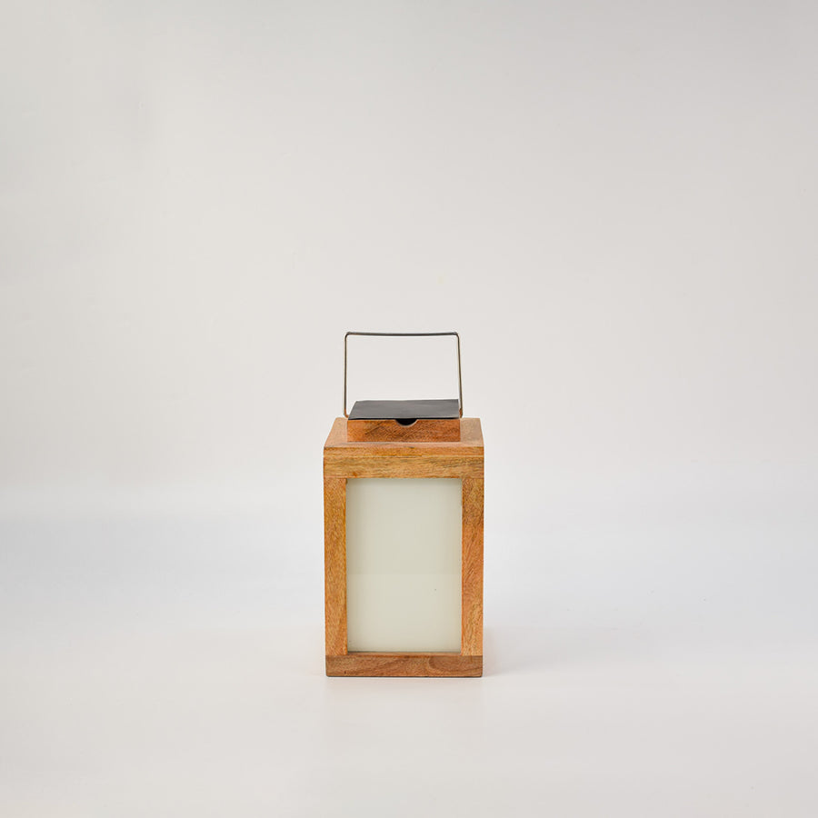 Wooden lantern with frosted glass panels and metal handle for modern tabletop and home decor styling.