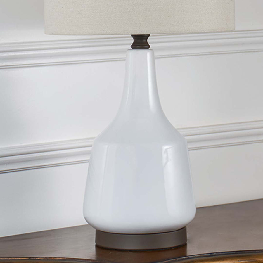 Closeup of White Ceramic Table Lamp showing smooth glazed ceramic base and finely textured beige lampshade for a modern minimal look.