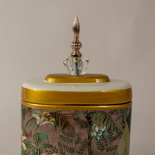 Closeup of decorative jar showing detailed hand-painted floral pattern and gold crystal finial.