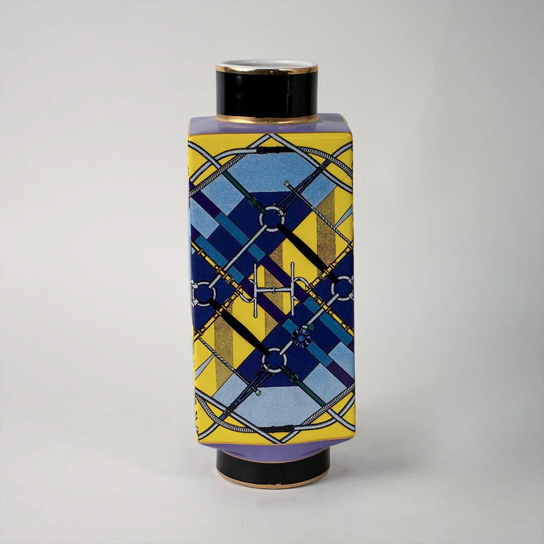 White background image ceramic jar vase with modern geometric blue and yellow artwork and black lid elegant home accent