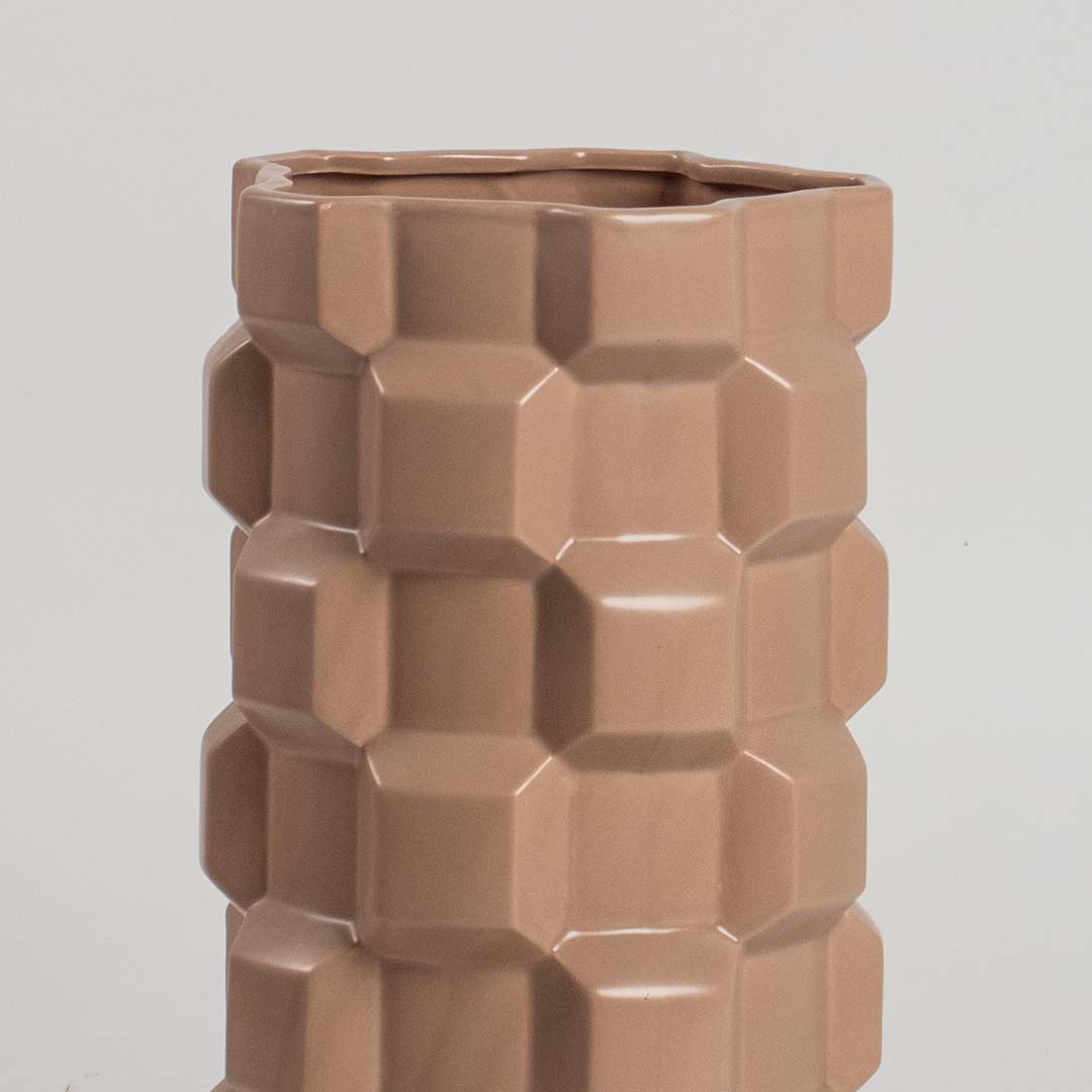 Closeup of brown ceramic vase highlighting its bold geometric textured pattern and glossy finish ideal for modern stylish decor.