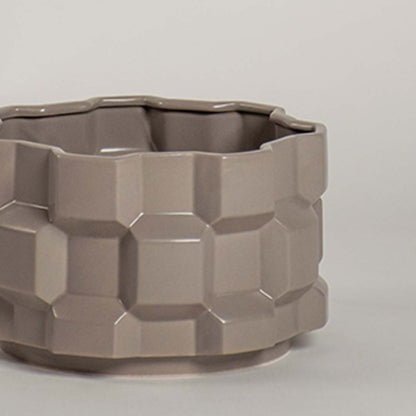 Closeup view of the taupe geometric ceramic planter highlighting the textured pattern and smooth ceramic finish.