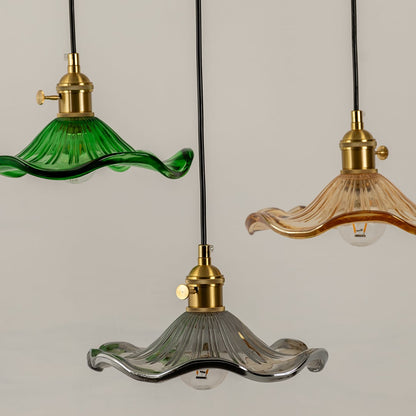 Green amber and clear textured glass pendant lights illuminated to showcase luxury modern ceiling lighting design.