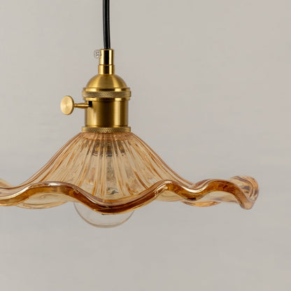 Amber textured glass pendant light closeup showcasing artisanal glass detailing and premium lighting craftsmanship.