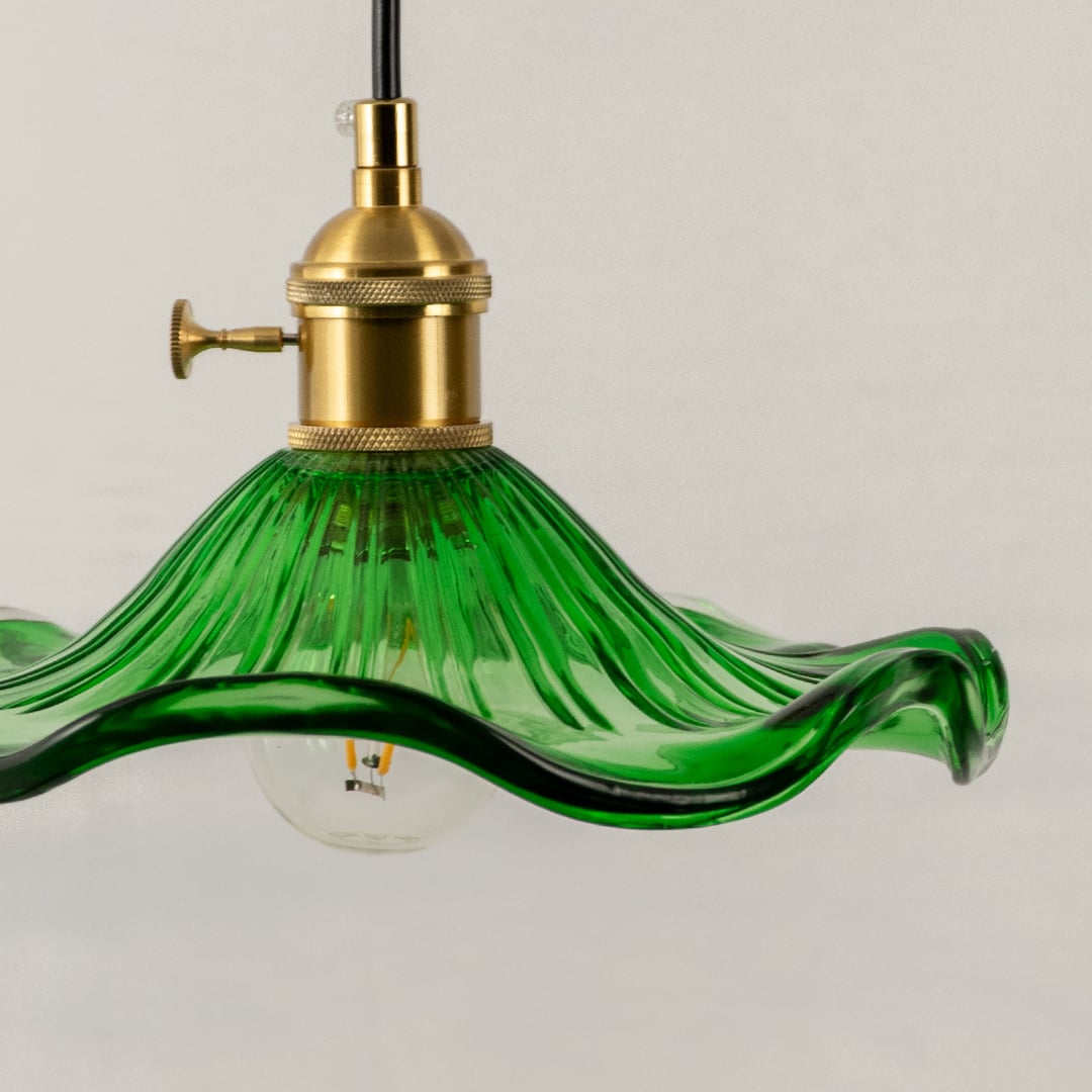 Green textured glass pendant light closeup highlighting artisanal detailing and premium decorative lighting craftsmanship.