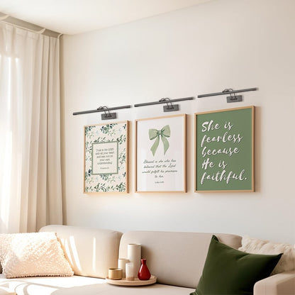Grouped lifestyle view of modern metal picture lights enhancing wall art and home decor styling.
