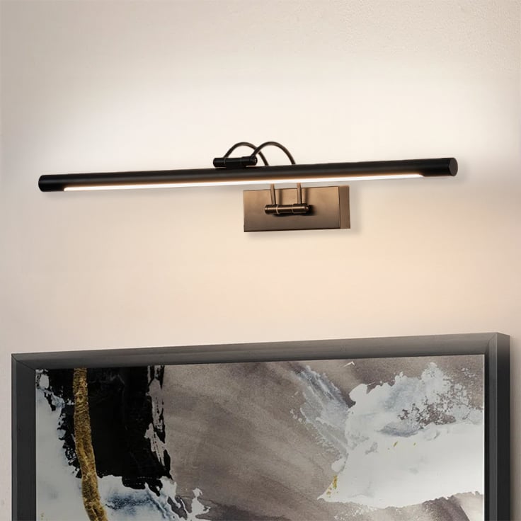 Closeup lifestyle view of black metal picture light mounted on the wall giving precise lighting for artwork and decor.
