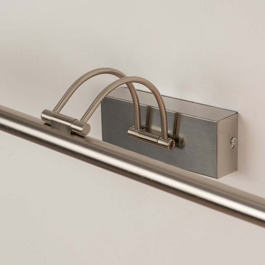 Closeup view of modern metal picture light with slim adjustable bar for focused wall illumination.