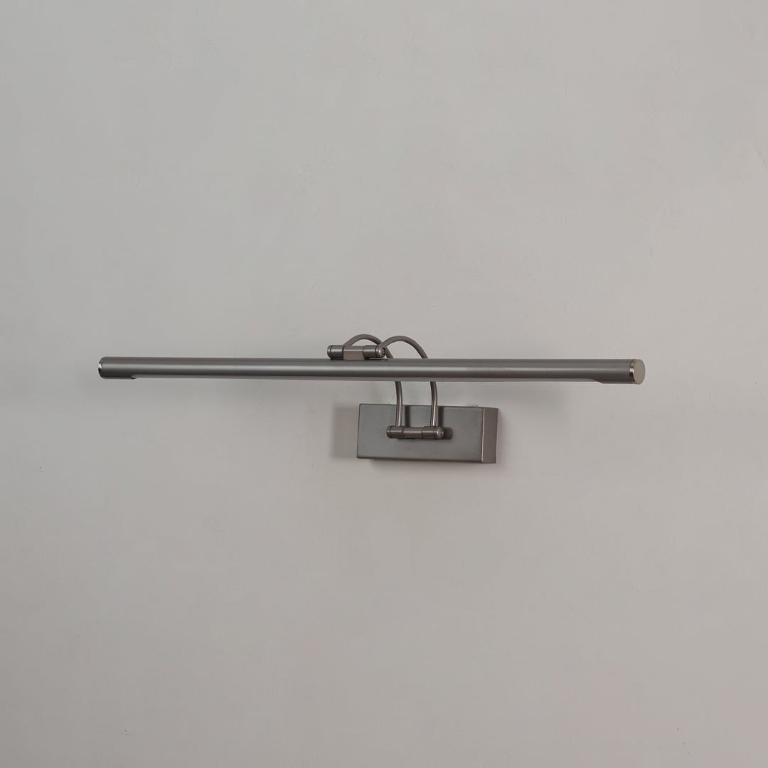 Metal wall picture light displayed on white background with adjustable bar for clean home decor.