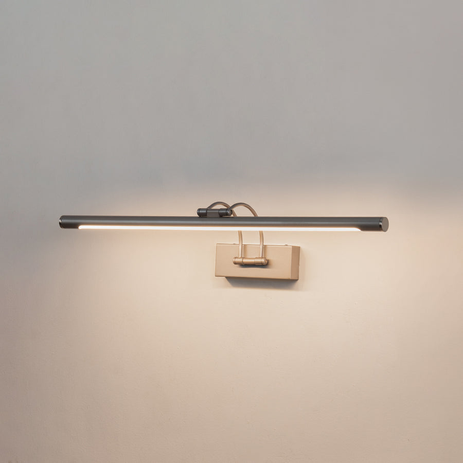Contemporary wall light in silver metal finish with linear bar design for bathroom or vanity decor lighting white background.