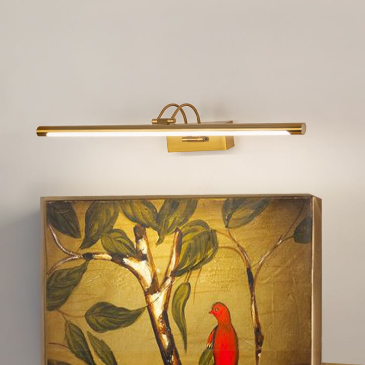 Gold metal picture light illuminating artwork with warm focused lighting creating elegant gallery style wall decor.