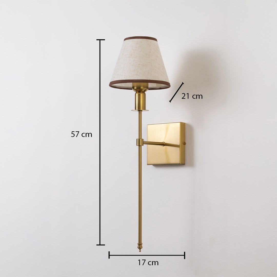 Gold wall sconce with beige shade shown with 57 cm height 17 cm width and 21 cm depth for accurate placement.