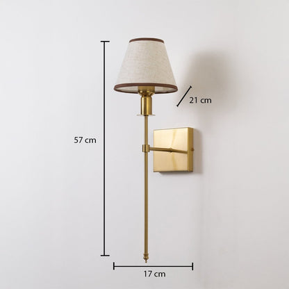 Gold wall sconce with beige shade shown with 57 cm height 17 cm width and 21 cm depth for accurate placement.