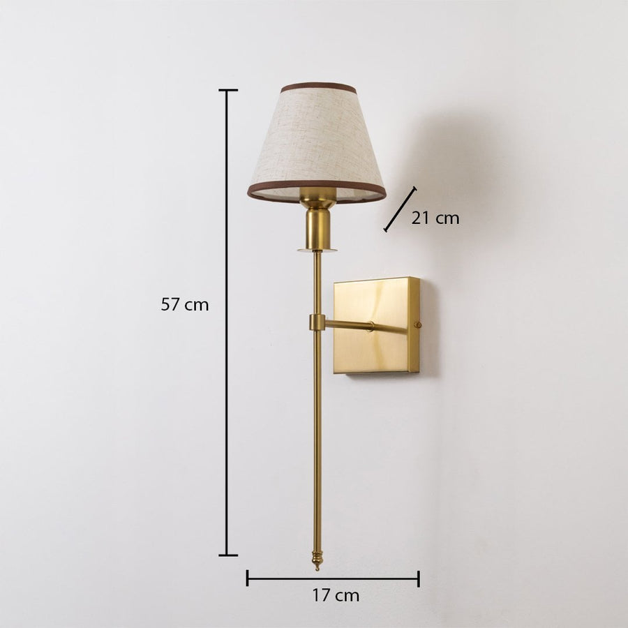 Gold wall sconce with beige shade shown with 57 cm height 17 cm width and 21 cm depth for accurate placement.