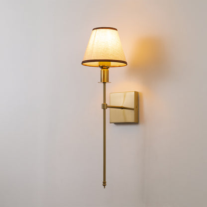 Modern wall light in gold metal finish with fabric shade for bedroom or living room decor lighting white background.