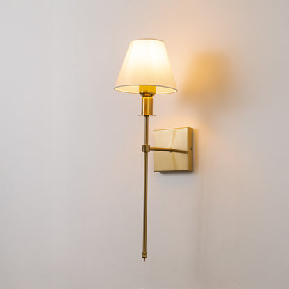 Elegant wall light in gold metal finish with fabric shade for bedroom or living room ambient lighting decor white background.