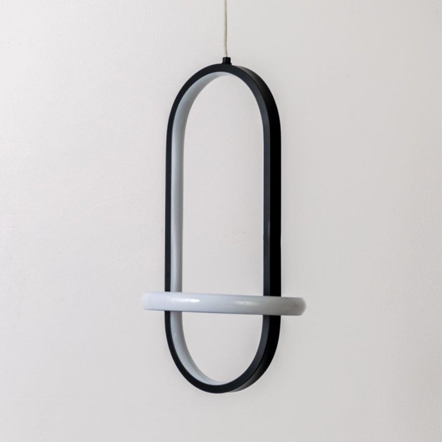 Modern black and white metal oval hanging light shown switched off on white background for minimal home decor styling.