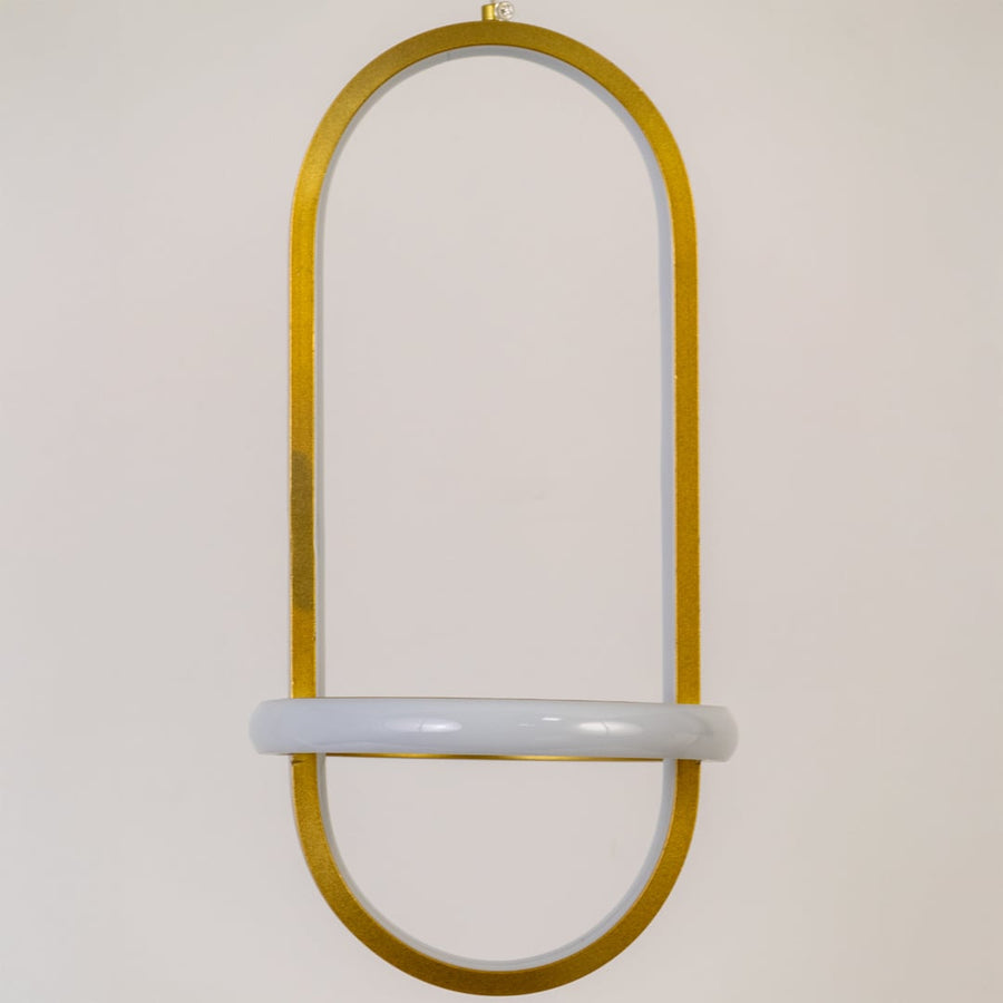 Closeup of gold and white metal oval hanging light showing smooth finish and premium modern design detailing.