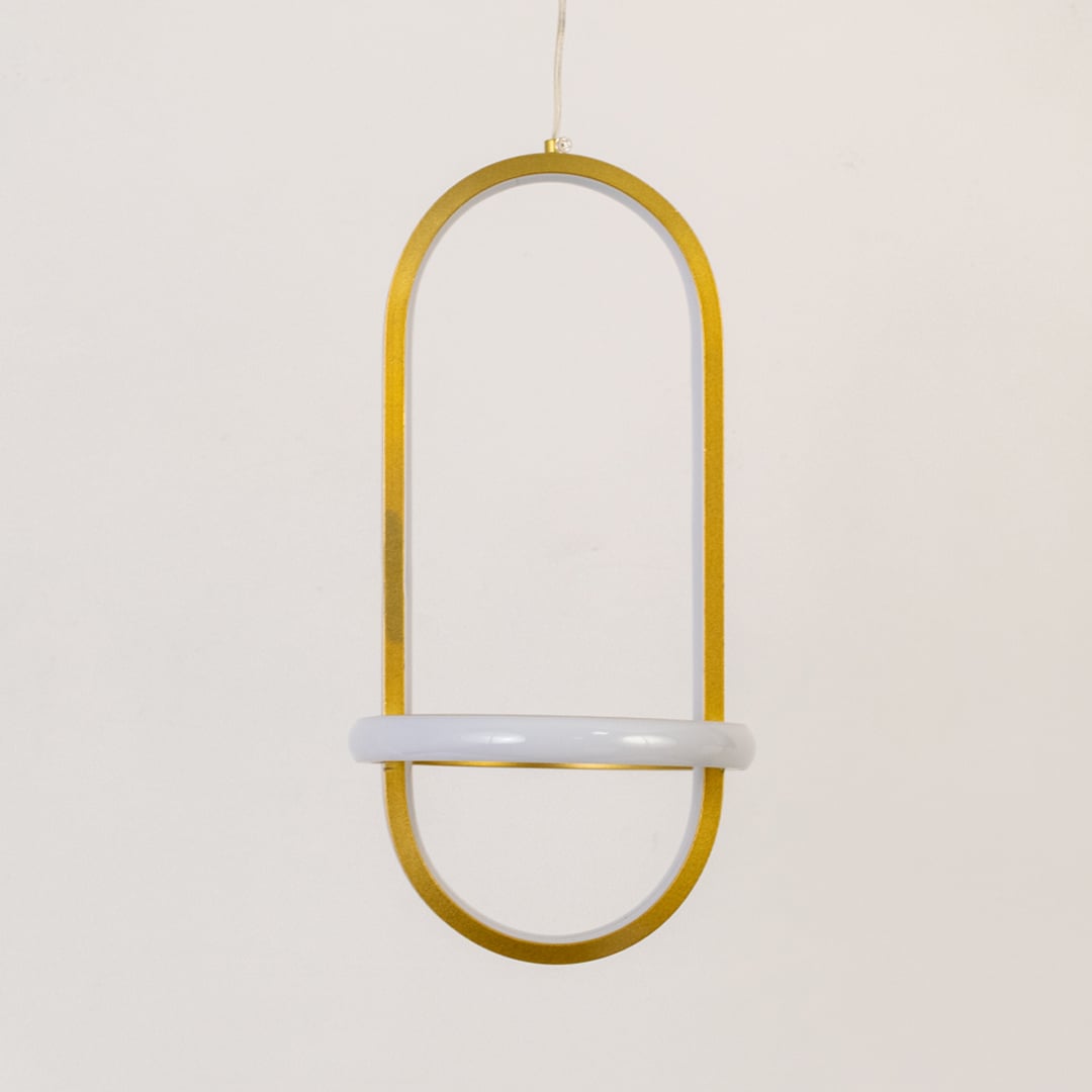 Gold and white metal oval hanging light shown switched off on white background for simple minimal wall decor.