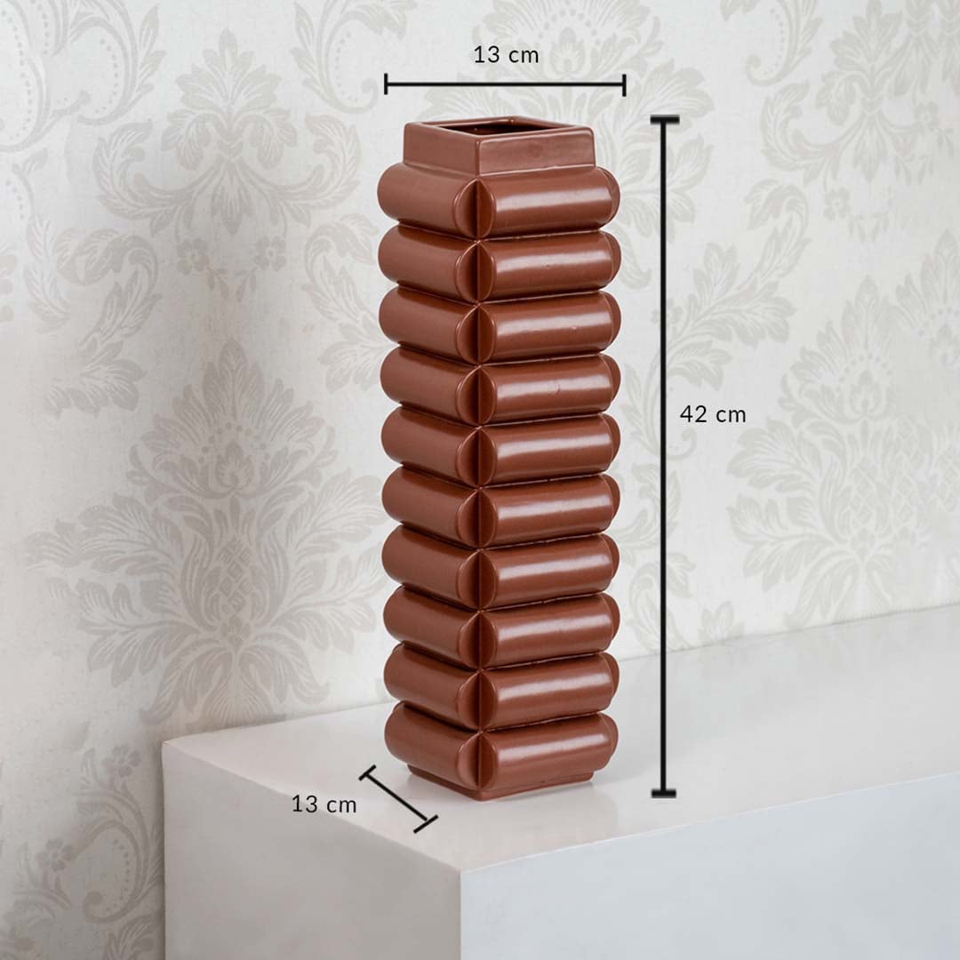 Brown ceramic decorative vase with ribbed design height 42cm width 13cm shown on white background.