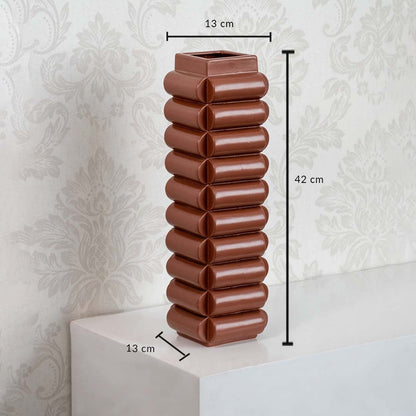 Brown ceramic decorative vase with ribbed design height 42cm width 13cm shown on white background.